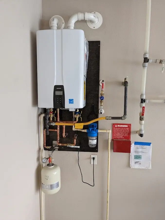 Professional plumber installing copper piping in a Golf Manor home